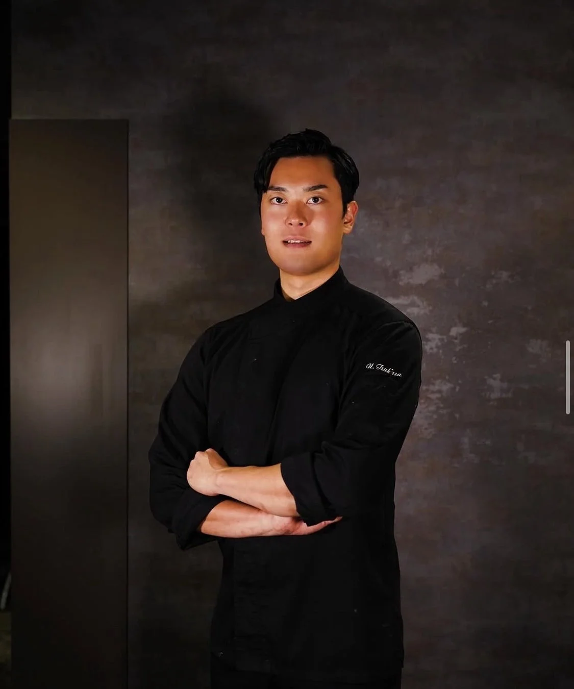 黒いコックコートを着用し腕を組んで立つ浦口司氏