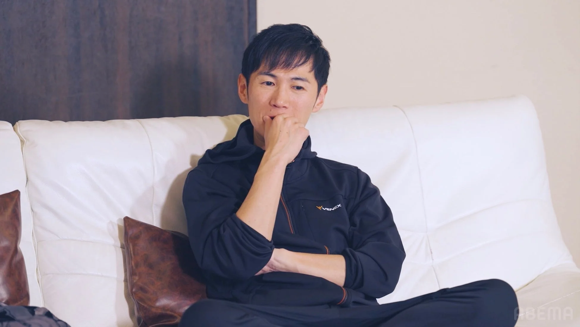 ソファに座って考え込む男性